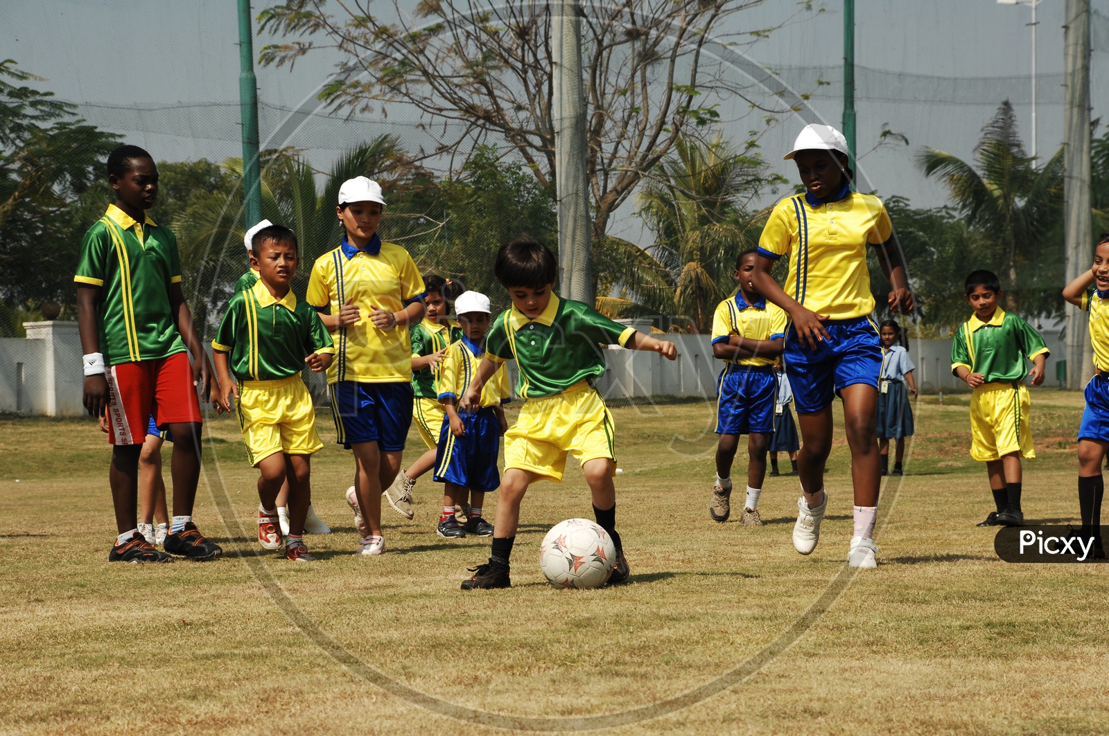 Children playing football in uniform