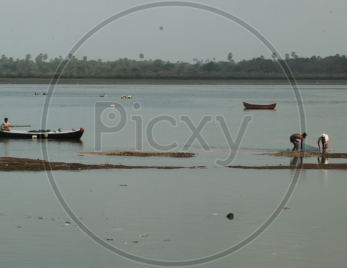 Fisherman On The Fishing Boats in a River