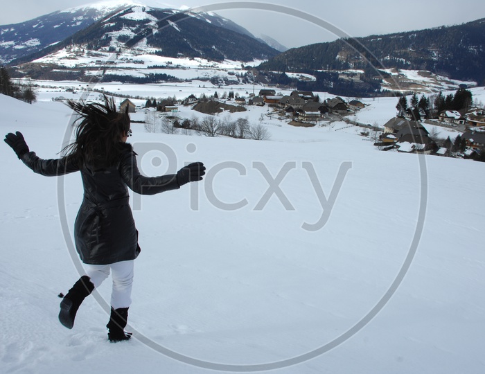 An Indian Girl Enjoying in  Snow Capped Mountains