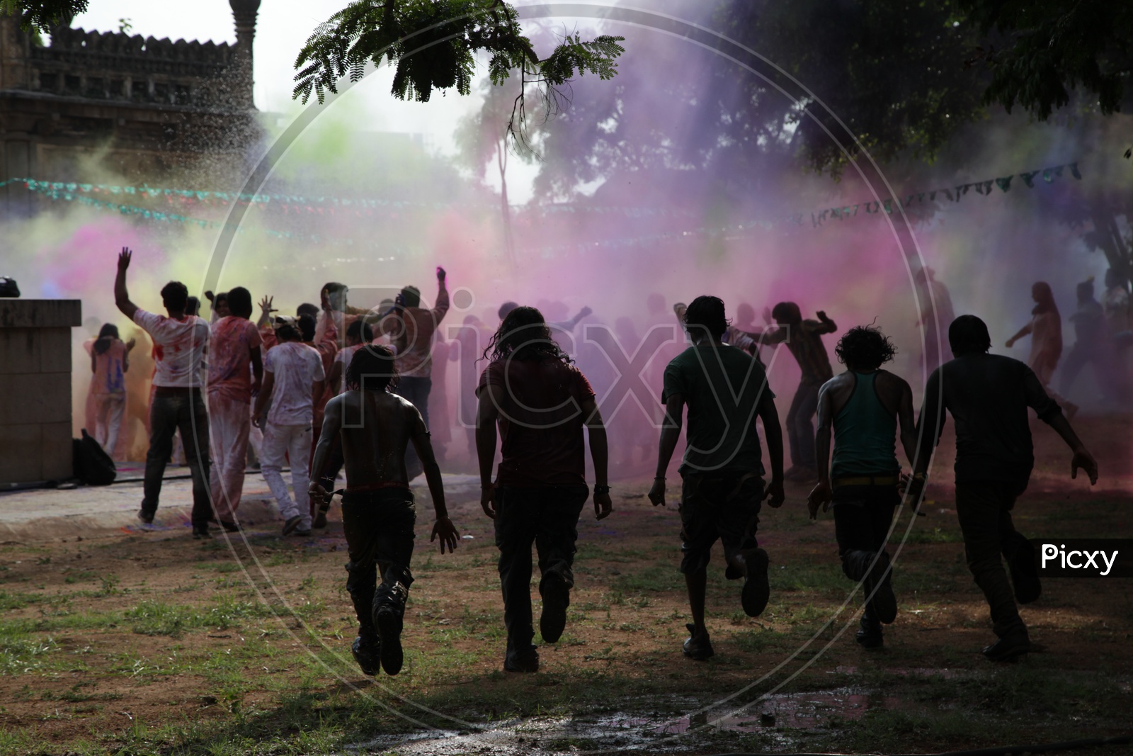 People celebrating holi / People throwing colors to each other during the Holi celebration