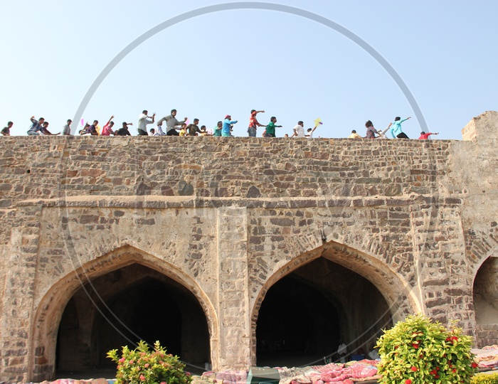 People Running on the Roof tops of Golconda