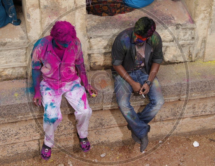 Two People Smoking After Holi Celebrations