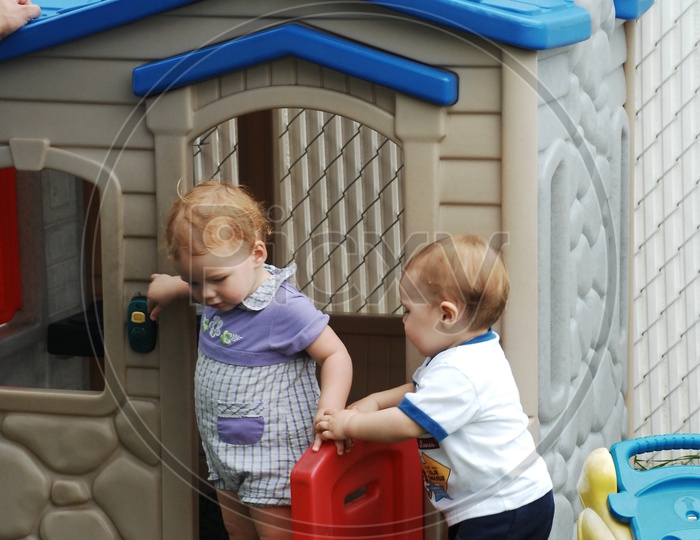 Children / Kids Playing in Toy House  and Smiling
