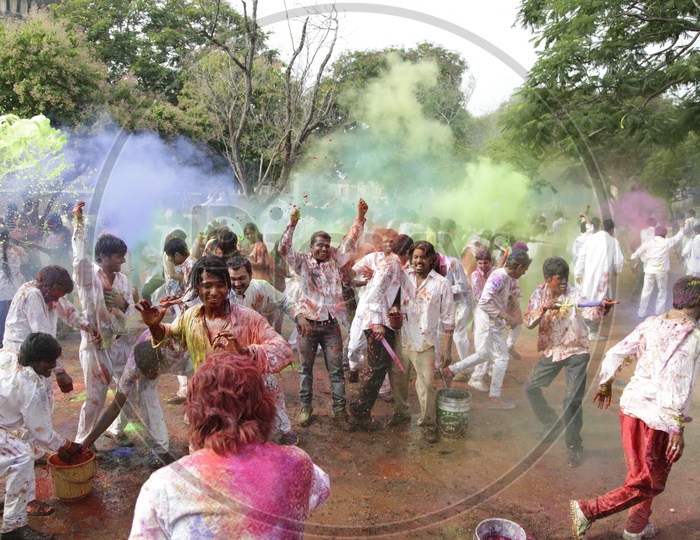 people celebrating holi / people throwing colors on each other in Holi Celebrations