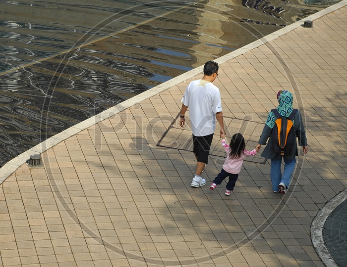 A Family Walking along a Pathway Besides Lake
