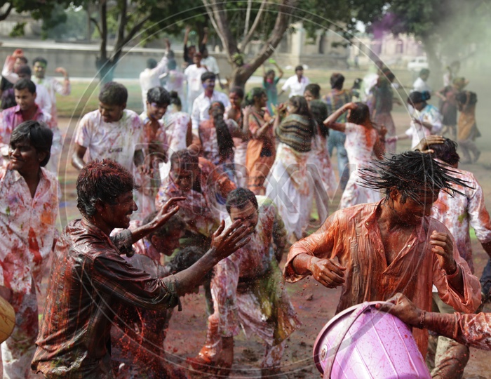 People celebrating holi festival / People throwing colors to each other during the Holi celebration in Hyderabad