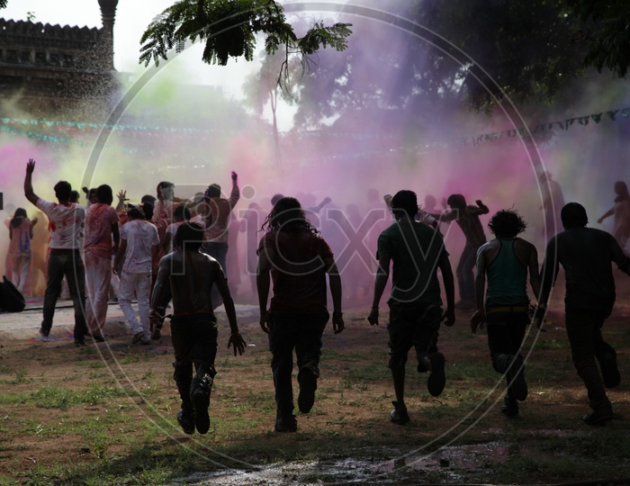 People celebrating holi / People throwing colors to each other during the Holi celebration