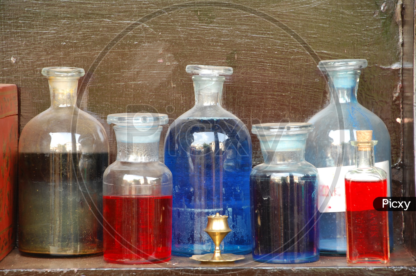 coloured Water Filled In Lad Glass Containers on a Table