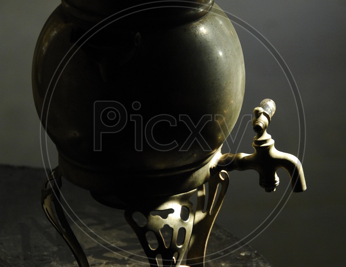 water pot made of brass with a tap