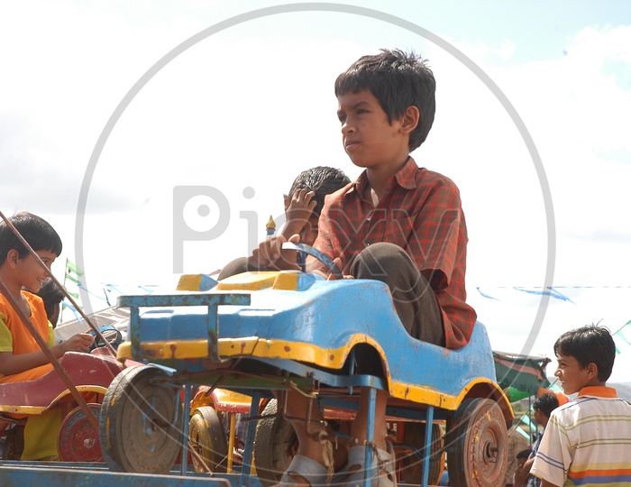Indian Kid/boy on a toy car