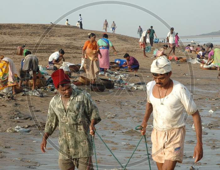 Fisher man Transferring their catch to the bank of River