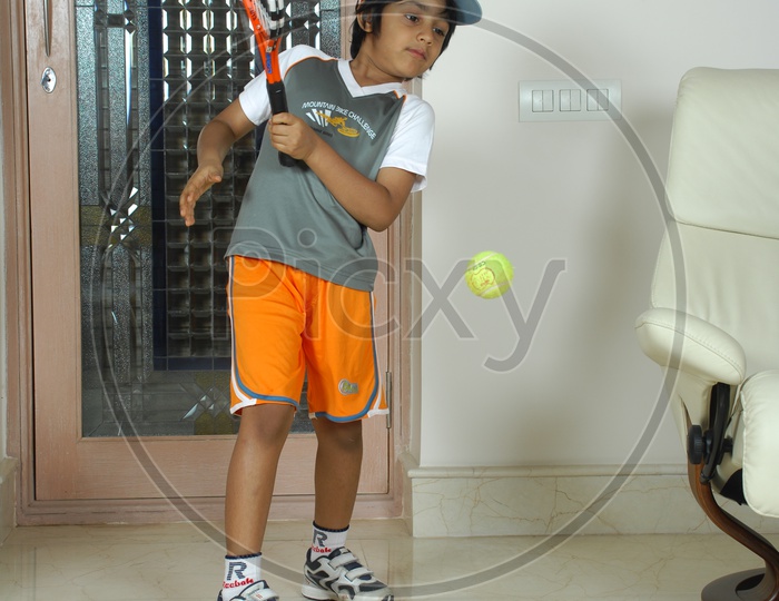 Indian Kid with Tennis Bat and Ball