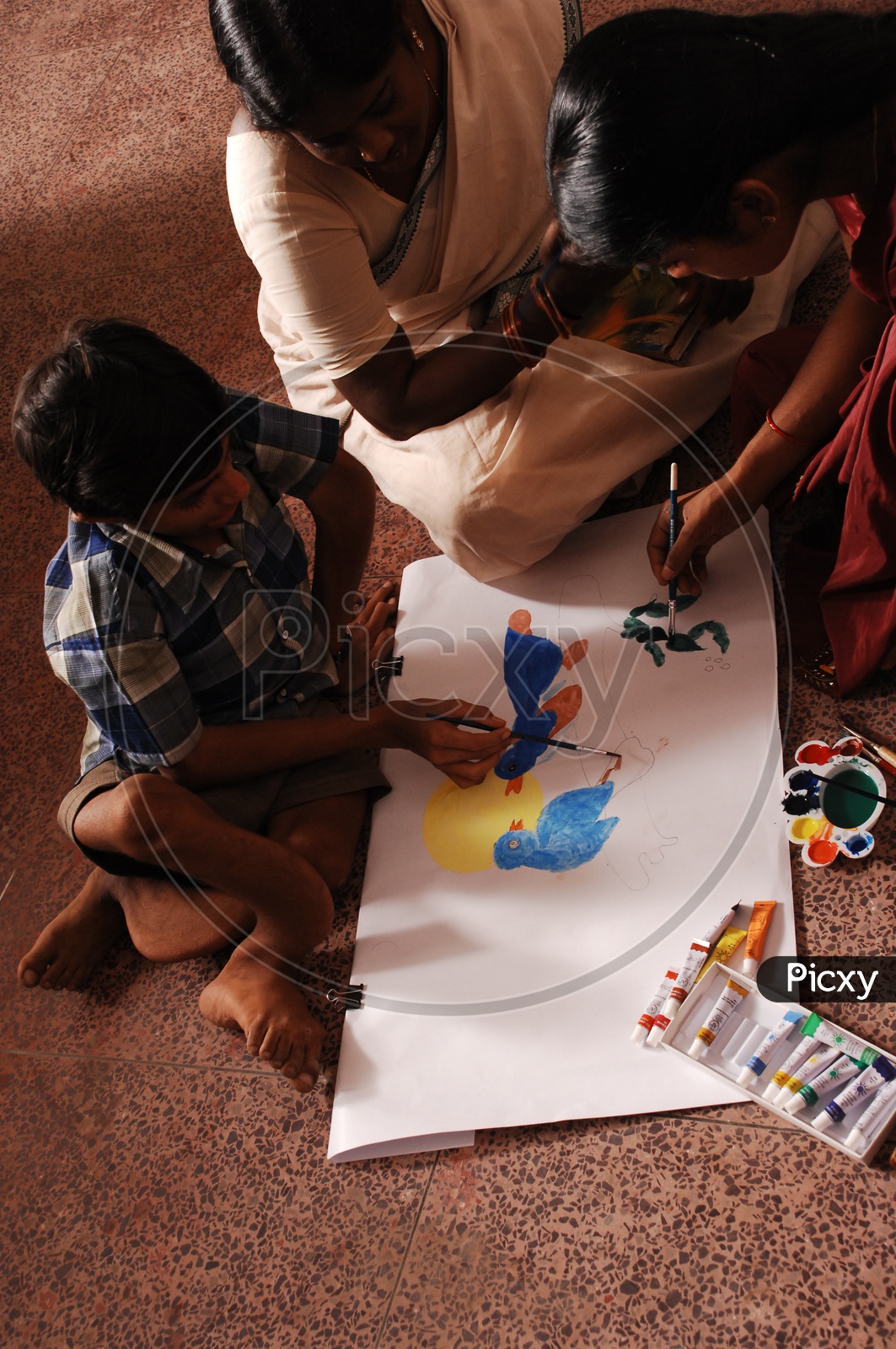 Differently abled School child doing a Painting On a Book