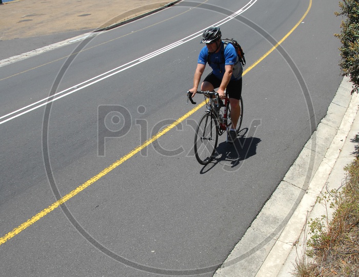 A Cyclist Cycling On a road