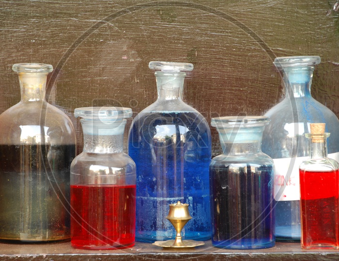 coloured Water Filled In Lad Glass Containers on a Table