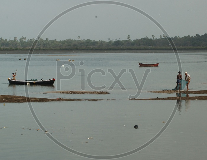 Fisherman On The Fishing Boats in a River