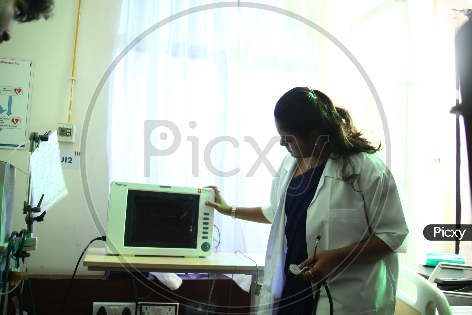 A Doctor Checking The patient Monitoring equipment in Hospital