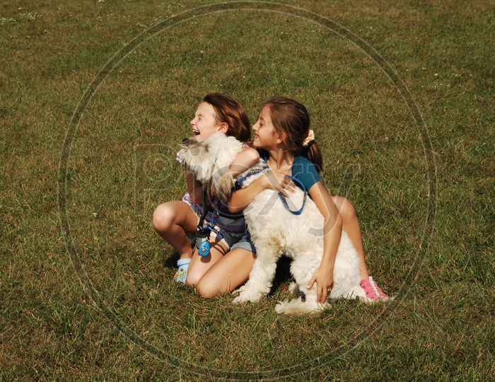 Girl Child Playing With a Dog