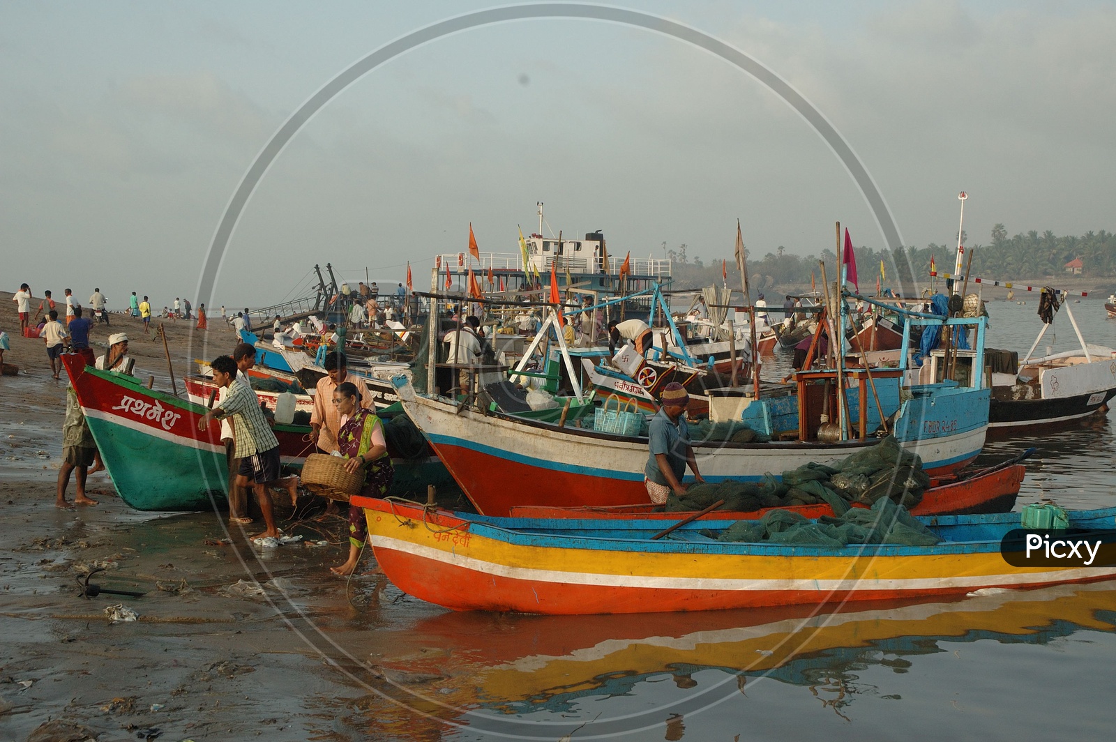 Fisher Man in Fishing Boats at the Bank of a River
