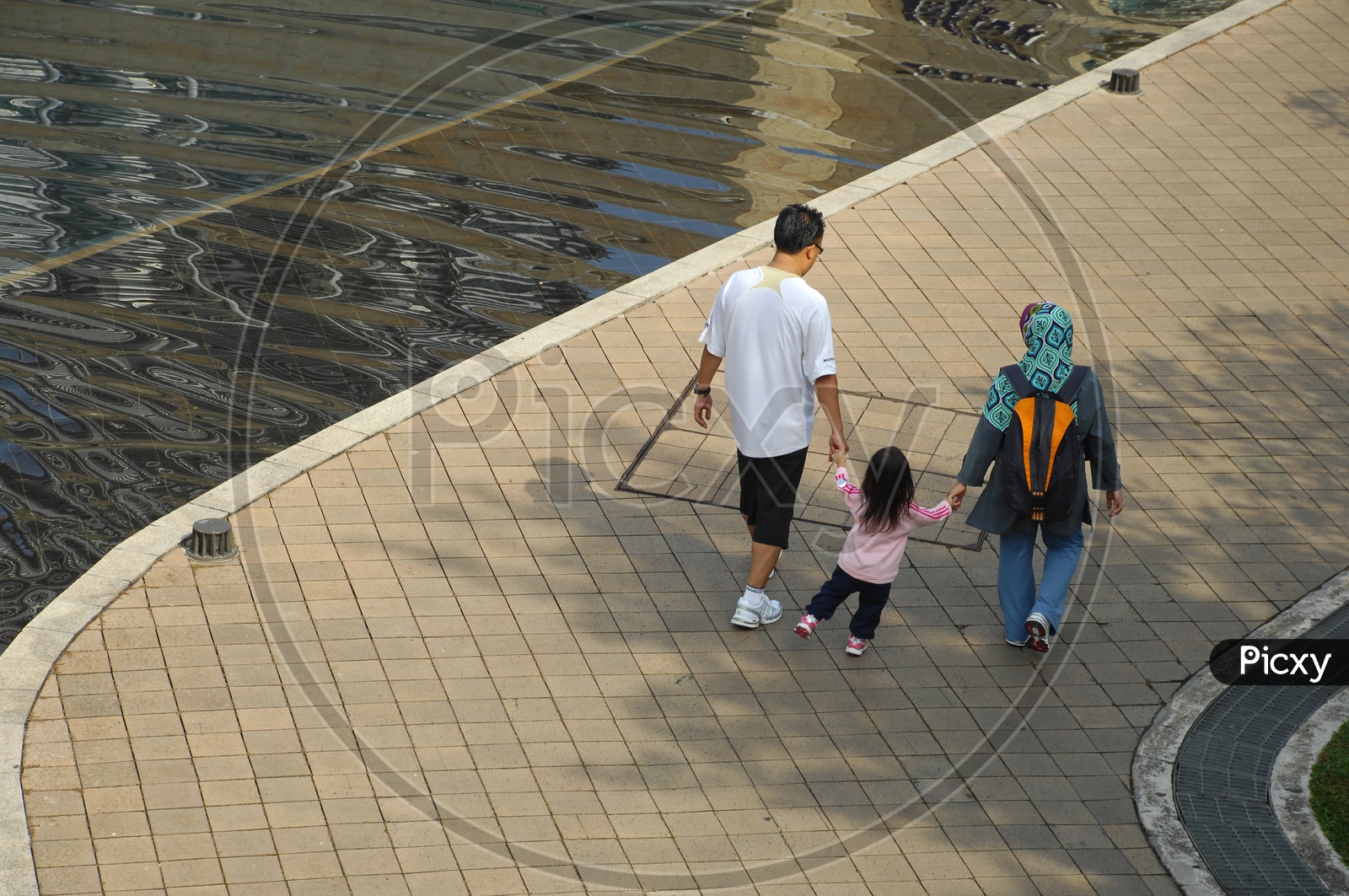 A Family Walking along a Pathway Besides Lake