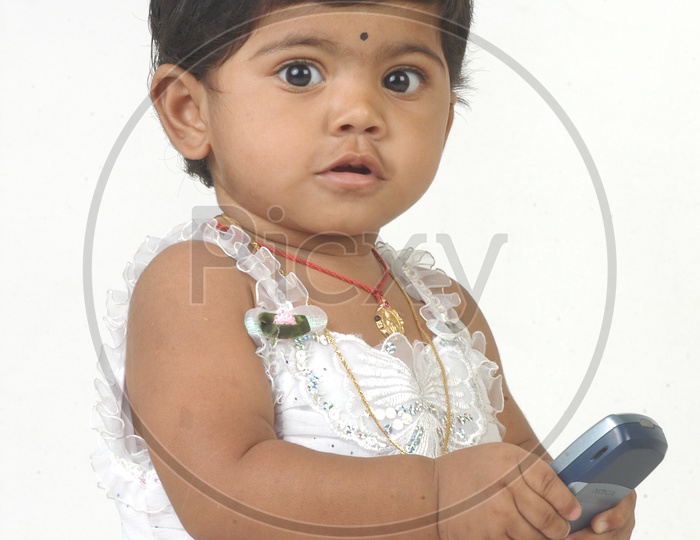 Indian Girl kid holding Mobile Phone