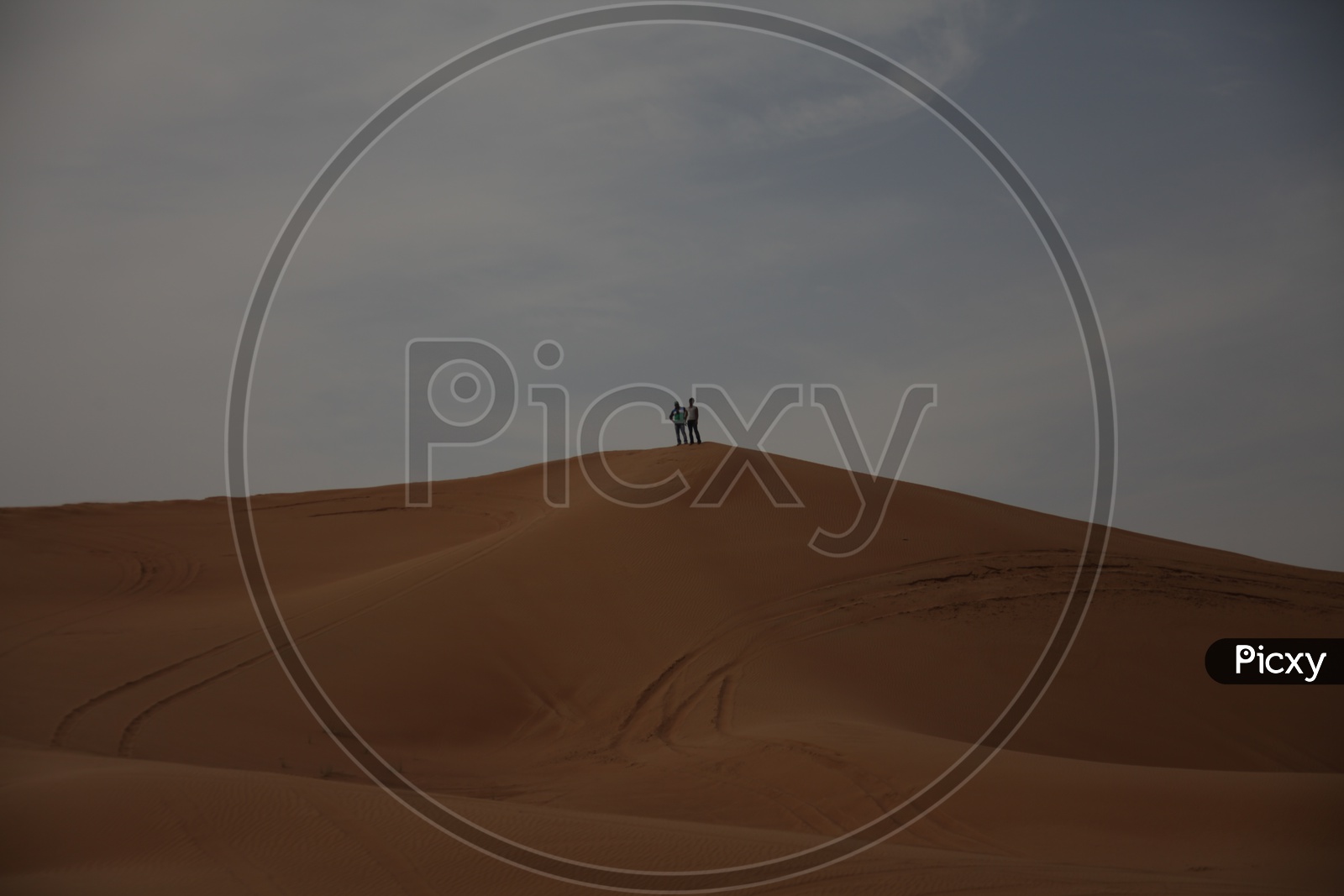 Man Standing On Sand Dunes in Desert