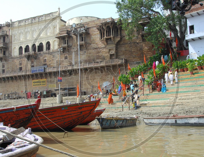 Sailing boats and Devotees on the River Bank Of Ganga in Varanasi