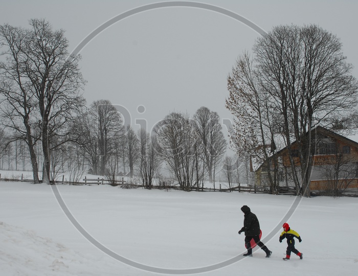 Children Playing and Running In The snow In Switzerland