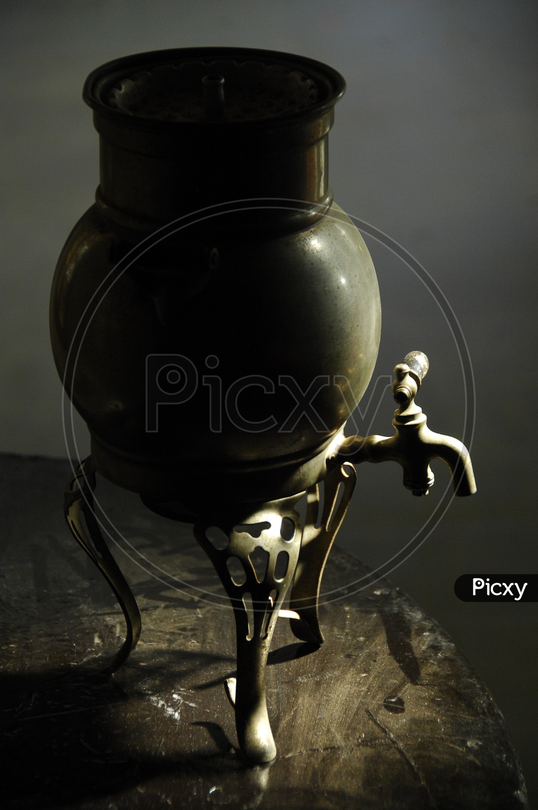 water pot made of brass with a tap
