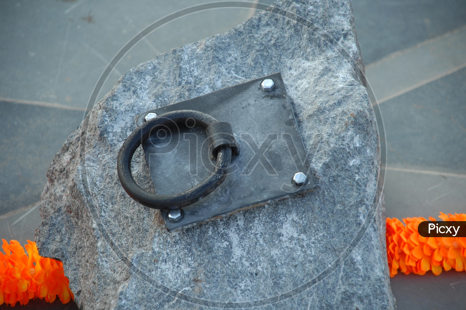 An Iron Clamp look like Ring Nailed To  a Stone