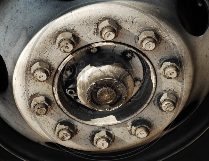 A Vehicle Tyre Rim With Nuts and Bolts Fitted