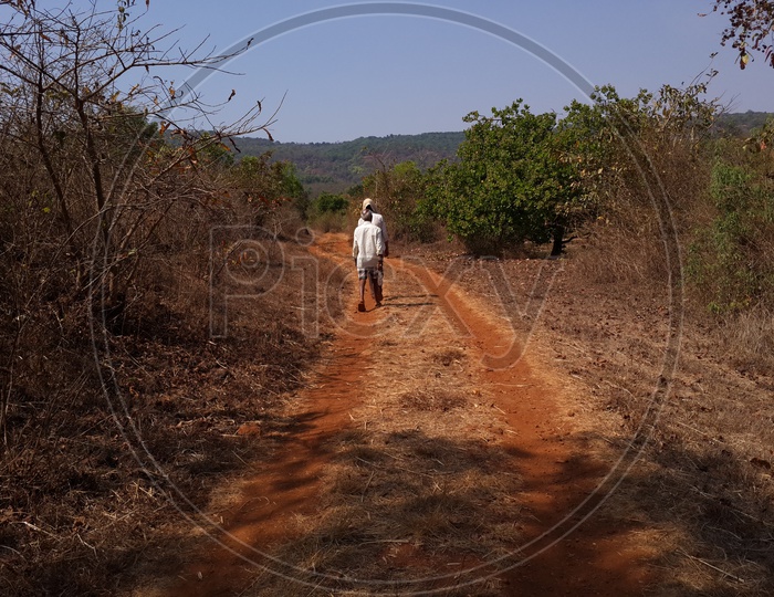 Old Man Walking On Pathways In Villages