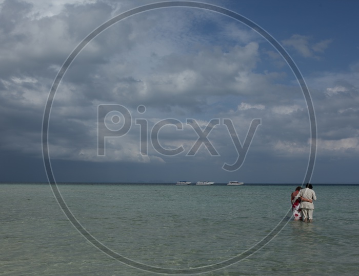 A Couple On a Sea Water In a Beach