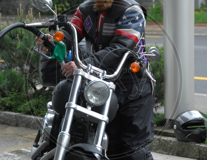 A Rider Filling Fuel In His Bike