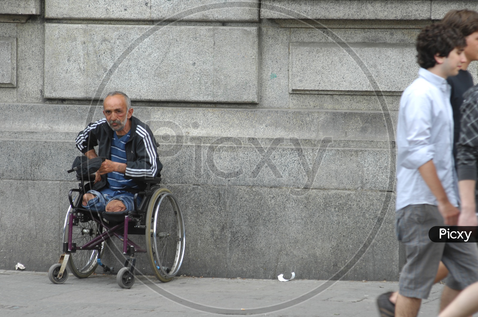 A handicapped old man in the wheelchair