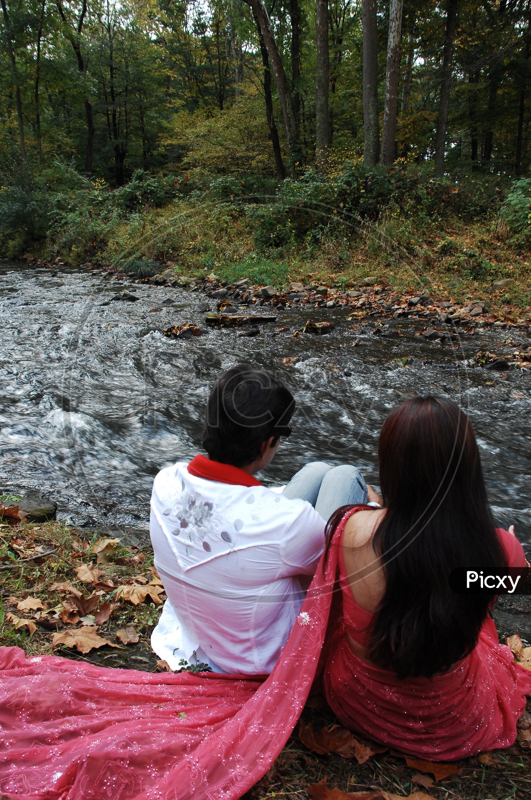Indian couple along the water stream