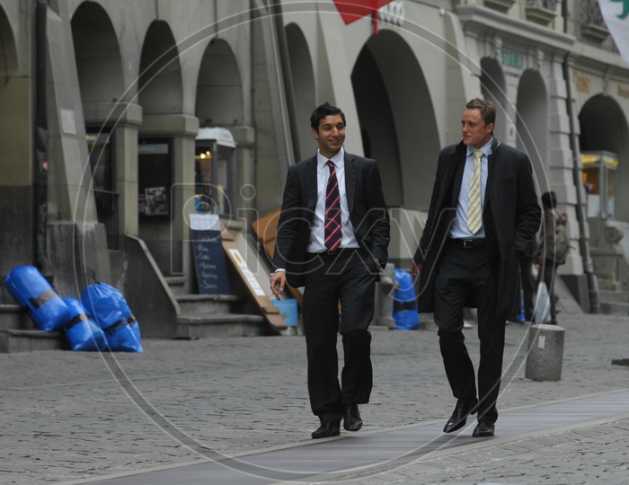 Professional Men  Walking Along  a Street
