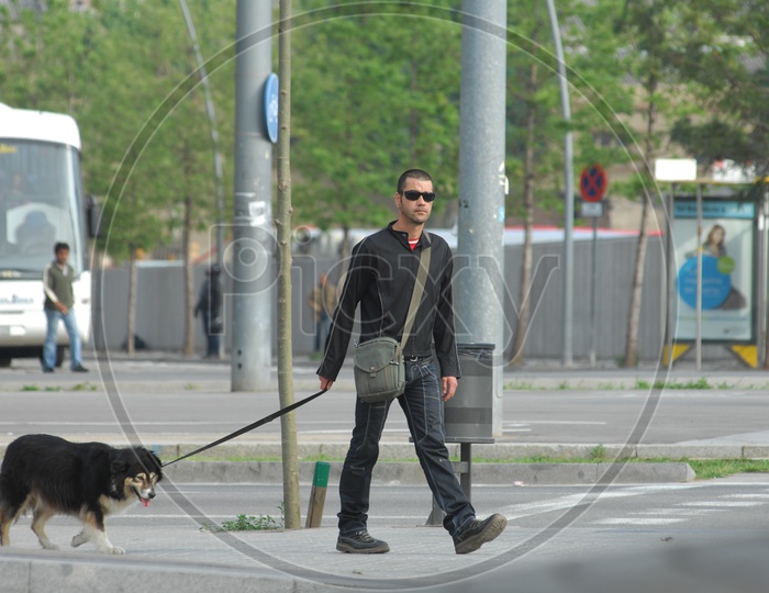 Man taking his pet dog for a walk