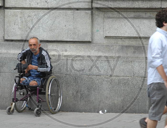 A handicapped old man in the wheelchair