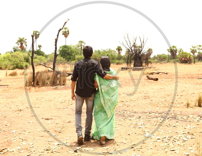 A man walking in a deserted area with an aged woman - Movie still
