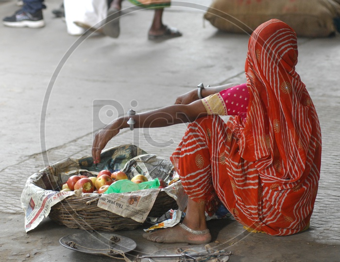 Photograph of a women selling fruits / People Face