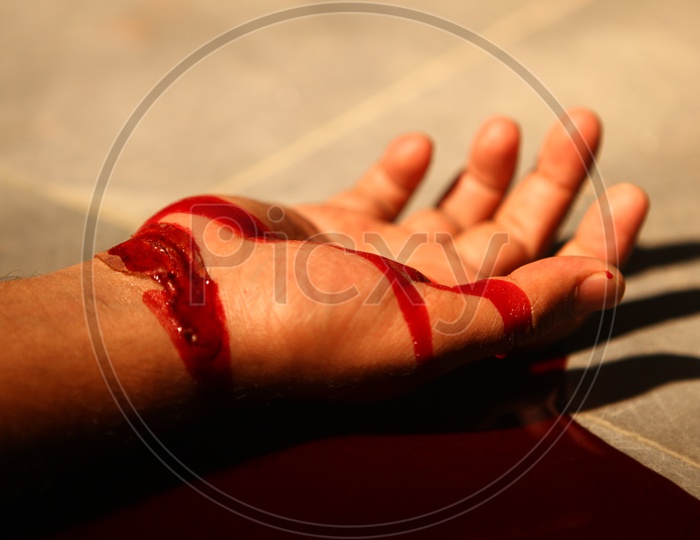 A Man Wrist Slit and blood on Ground Closeup Shot
