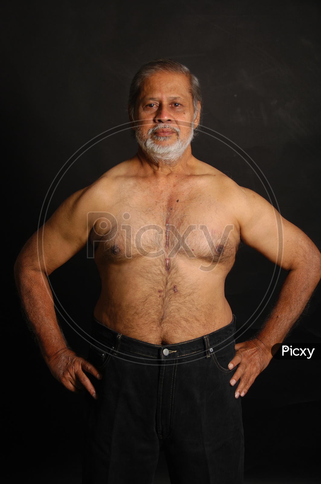 Photograph of a old man with studio lighting with black background / People Face