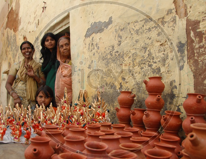 Photograph of a old women with pots in the foreground / People Faces