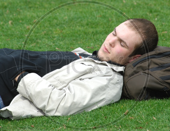 A Young Man Sleeping in a Lawn