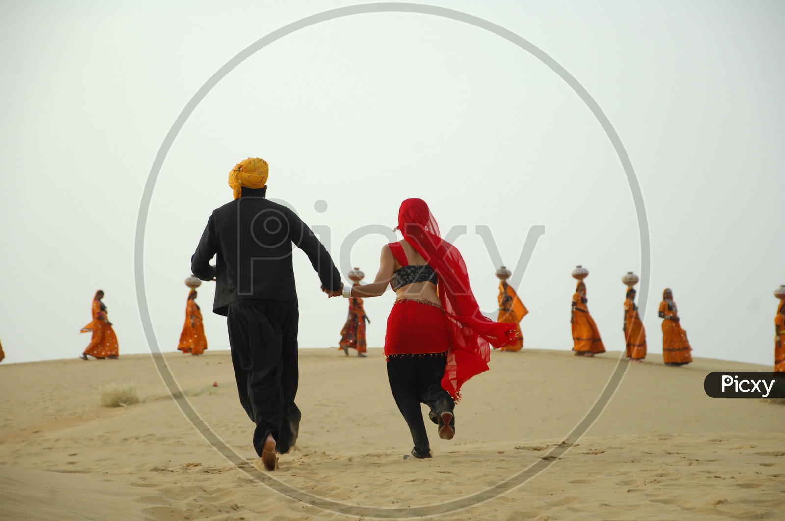 A man and woman running in a desert