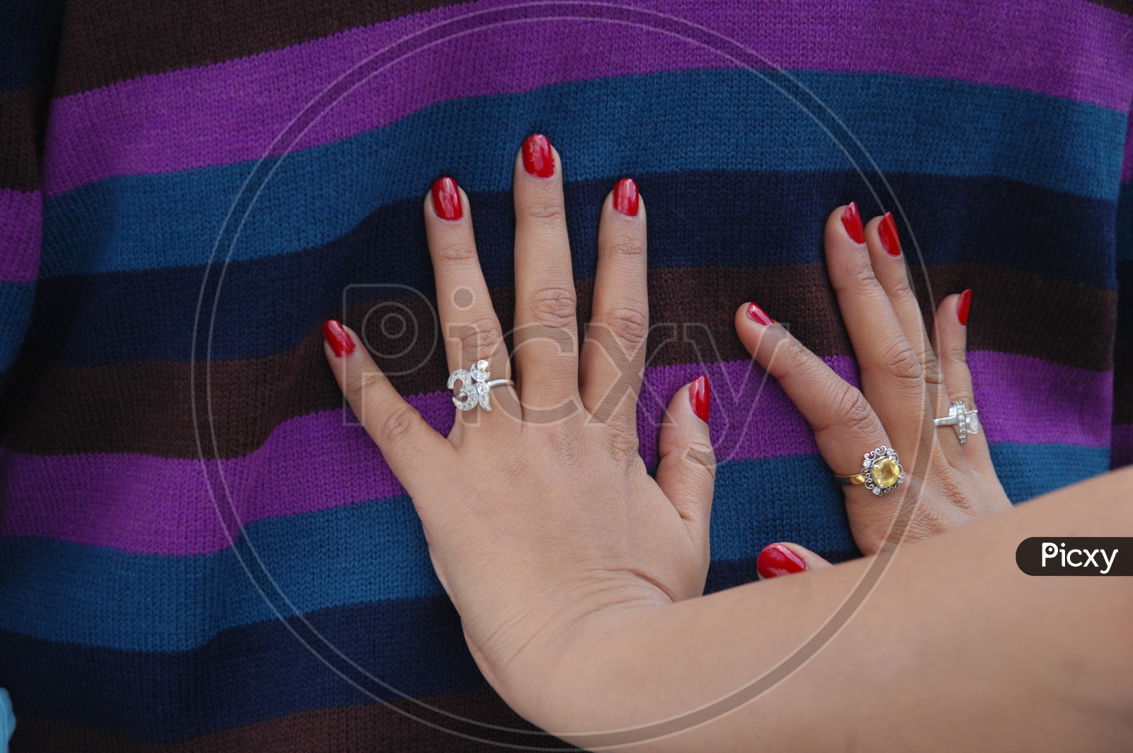 Woman's hands wearing Nail Polish and rings