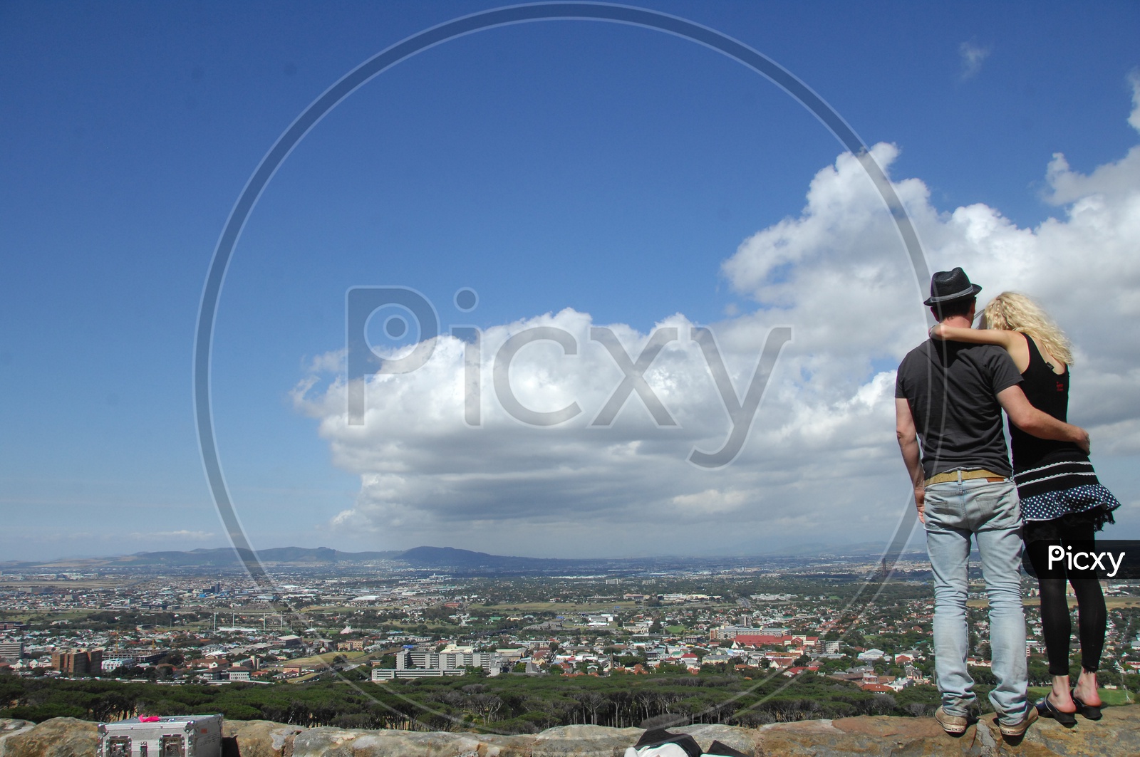A Foreign Couple Watching a City Scape From a Hill Top