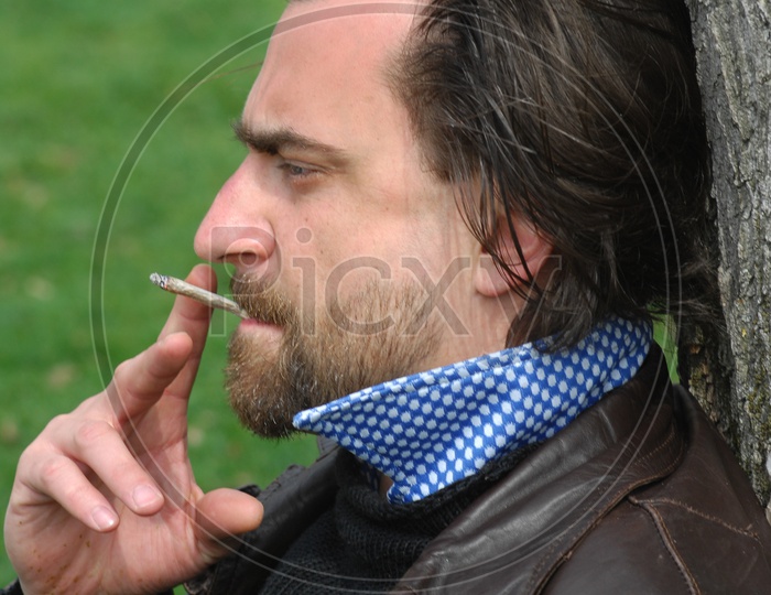 A Young Man Smoking On The Streets of Europe