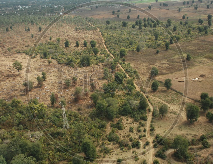 Aerial Views Of a Barren Lands With Trees From Flight Window